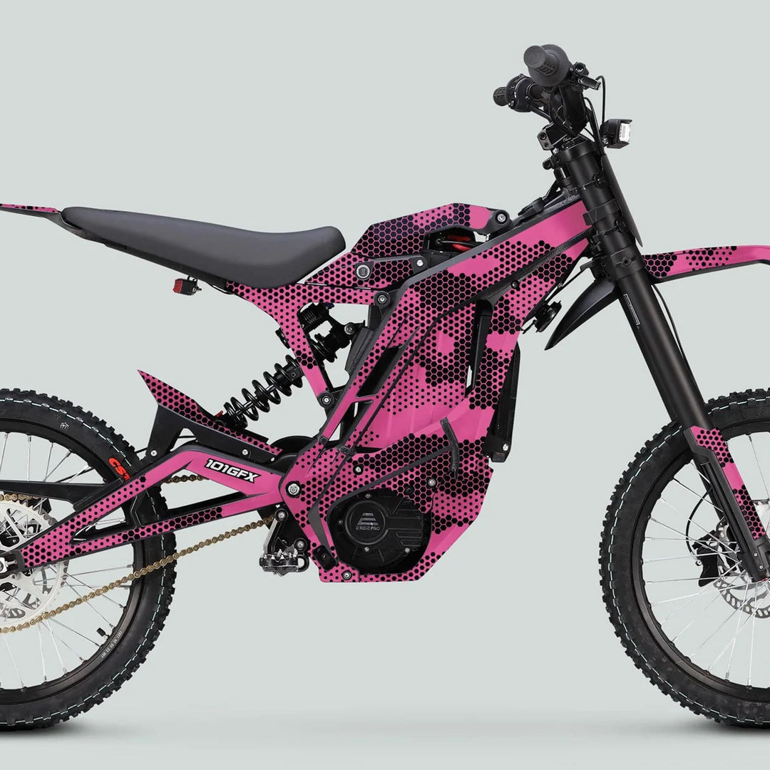 E Ride Pro SS Graphics Kit HEXOCAM PINK on electric dirt bike with tubular frame, knobby tires, and mid-mounted motor, showcasing striking pink/black design.