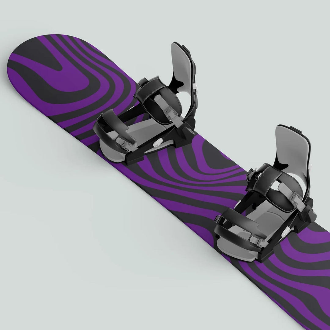 Snowboard with Snowboard Wrap WAVY BLACK PURPLE decals, featuring black-and-purple swirled graphics and black-grey bindings, enhancing style and protection.