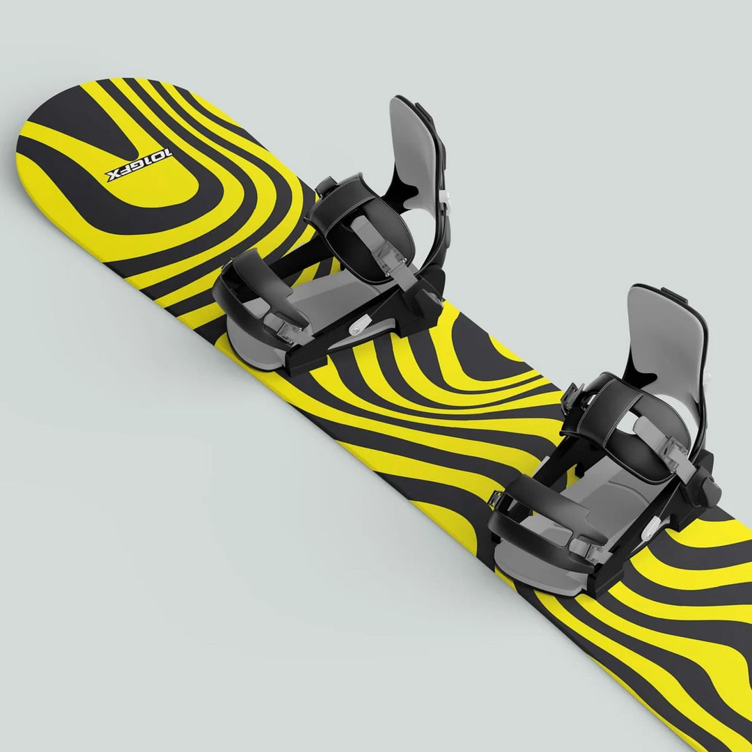 Snowboard featuring the Snowboard Wrap WAVY BLACK YELLOW, showcasing bold wavy graphics and two high-back, adjustable strap-in bindings for boots.