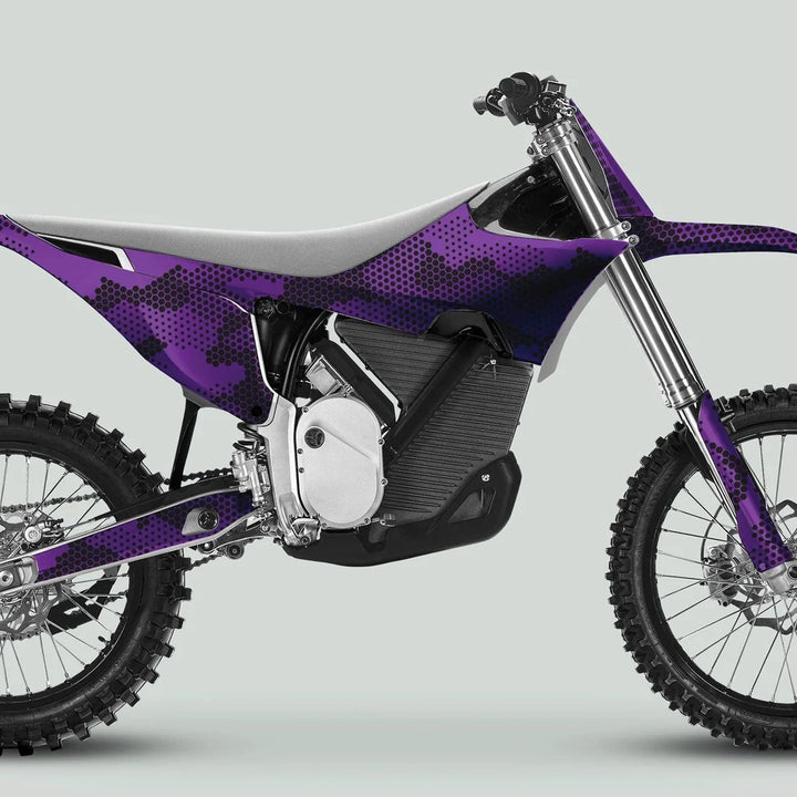 Side profile of electric dirt bike with Stark Varg Graphics Kit HEXOCAM Purple Decals, featuring knobby tires, purple camo design, and inverted front forks.