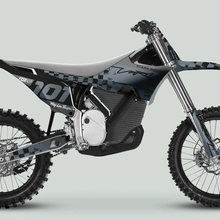Side profile of a dirt bike with Stark Varg Graphics Kit RACE BLACK Grey Decals Stickers, showcasing knobby tires and visible electric motor housing.