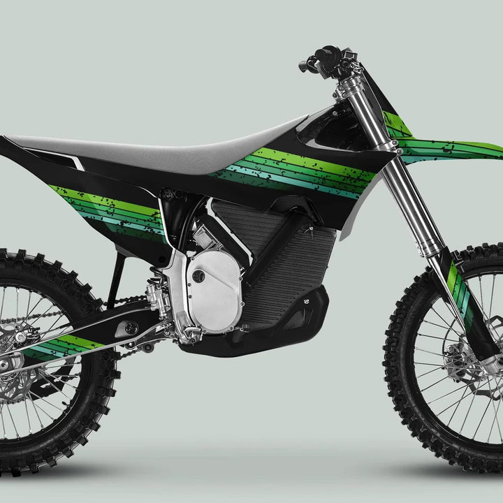Stark Varg Graphics Kit RETRO GREEN on a motocross bike, showcasing knobby tires, slim seat, and electric motor housing, enhancing style and protection.