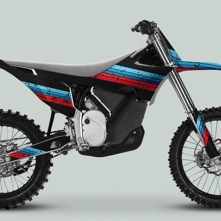 Side profile of a motocross bike with Stark Varg Graphics Kit RETRO BLUE RED Decals, featuring knobby tires and long-travel forks, emphasizing durability and vintage style.