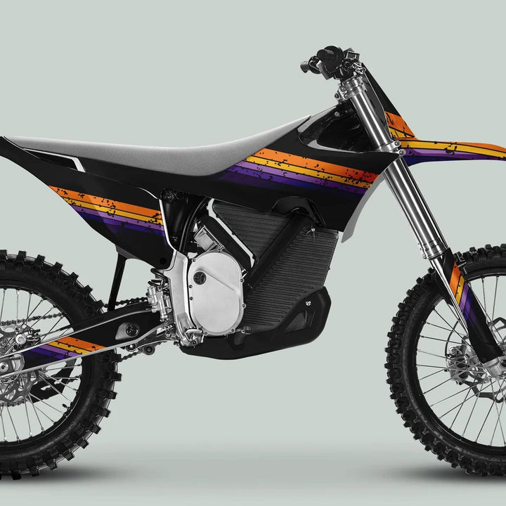 Side-view of an electric dirt bike featuring Stark Varg Graphics Kit RETRO YELLOW PURPLE Decals with orange and purple stripes on body panels.