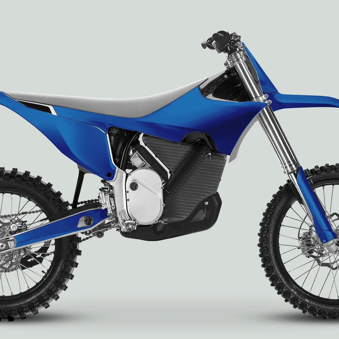 Electric dirt bike with Stark Varg Graphics Kit SOLID COLOR BLUE Stickers, showcasing knobby tires, upside-down fork, and sleek motocross design against a plain backdrop.