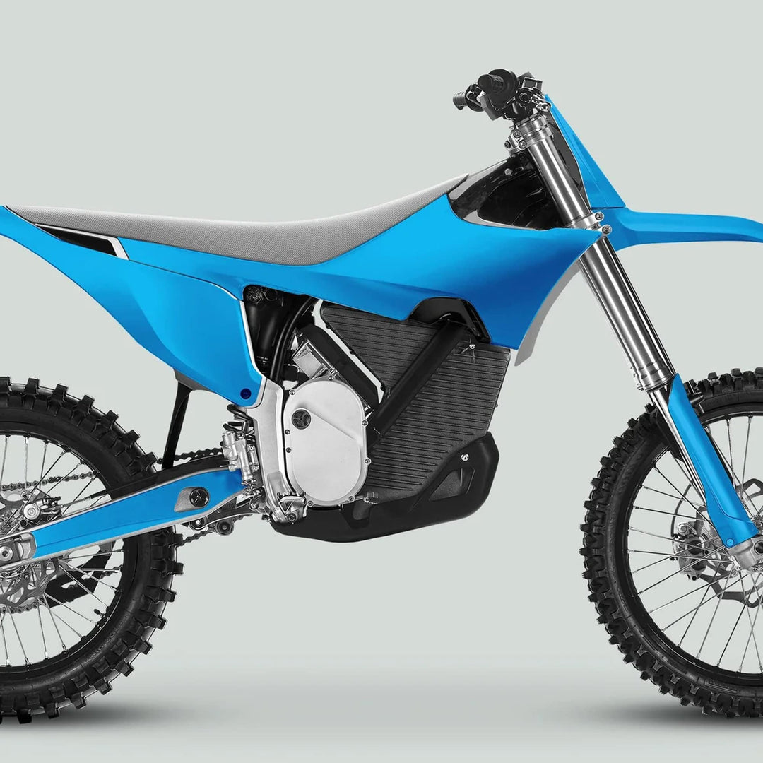 Side-profile of a bright blue electric motocross bike with Stark Varg Graphics Kit SOLID COLOR CYAN Stickers, featuring knobby tires and minimalist frame.