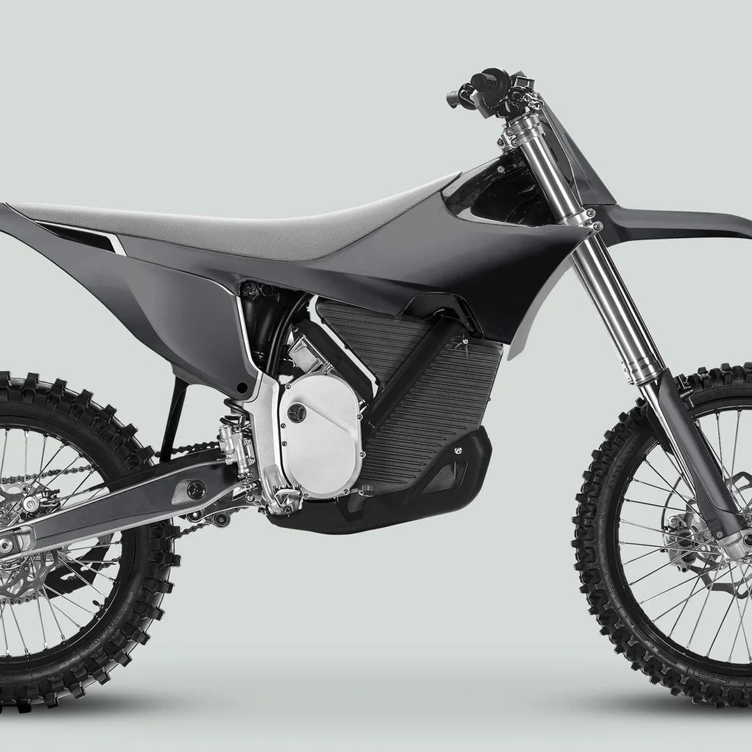 Stark Varg Graphics Kit SOLID COLOR GREY Stickers on a motocross-style electric dirt bike, showcasing off-road enhancements like knobby tires and streamlined body panels.