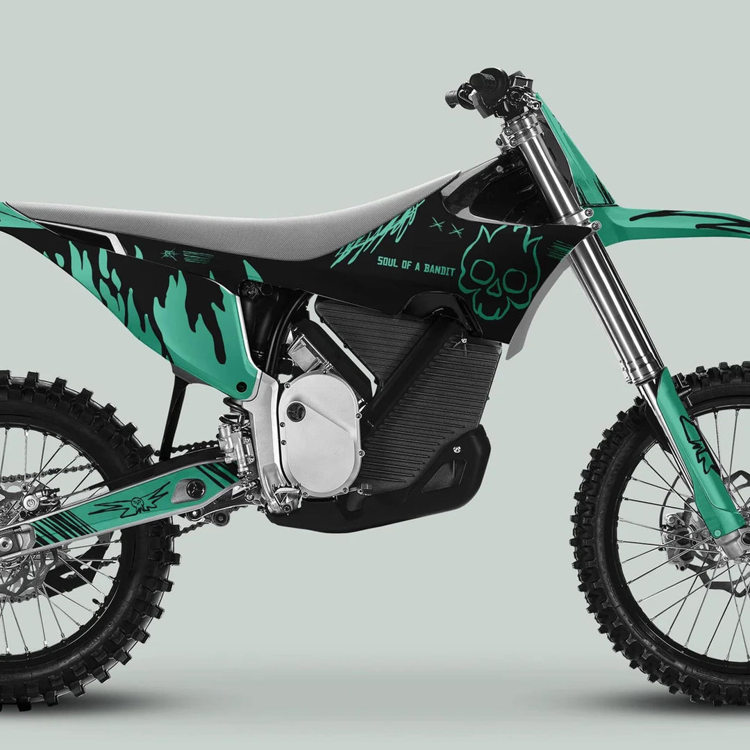 Stark Varg Graphics Kit SOUL FLAME Black Mint Decals Stickers on an electric motocross bike with knobby tires, black-teal livery, and flame-skull graphics.