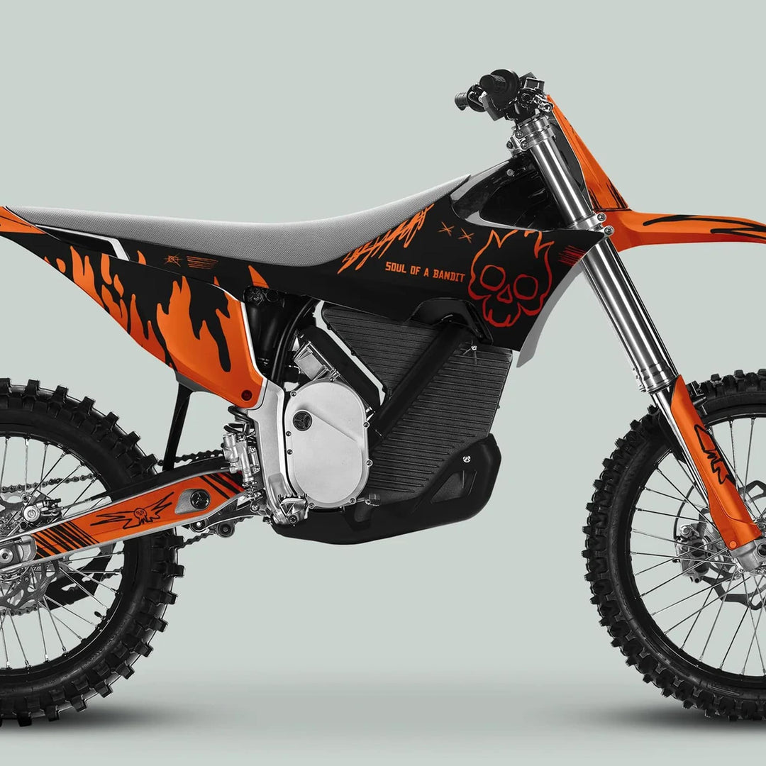 Side-view of a dirt bike featuring the Stark Varg Graphics Kit SOUL FLAME Black Orange Decals Stickers with flame graphics and Soul of a Bandit text.