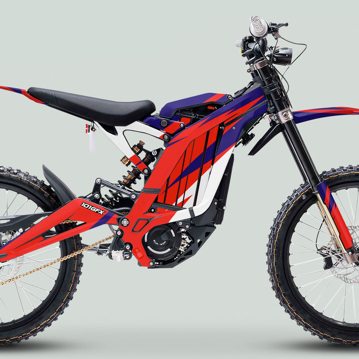 Surron Light Bee X Graphics Kit CRACK Blue Red on an electric dirt bike with spoked rims, disc brakes, and motocross-style seat.