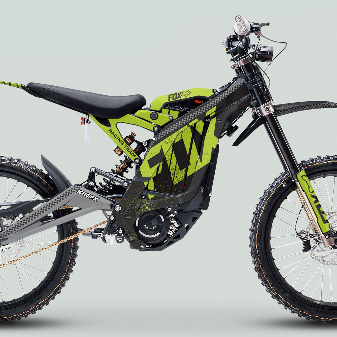 Surron Light Bee X Graphics Kit FOX DUST Black Green on an electric dirt bike, showcasing a modern design with durable decals, FOX-branded suspension, and knobby tires.
