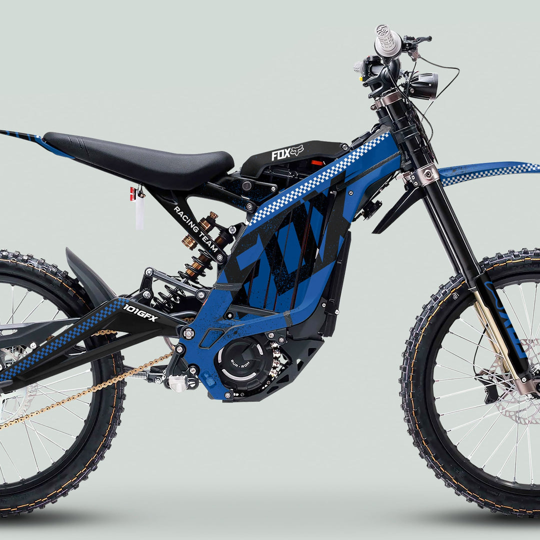Surron Light Bee X Graphics Kit FOX DUST Blue Black on blue motocross bike, showcasing tubular frame, suspension, knobby tires, and electric motor housing with chain drive.