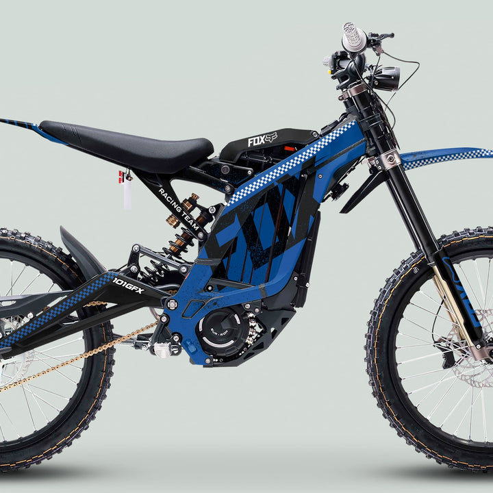 Surron Light Bee X Graphics Kit FOX DUST Blue Black on blue motocross bike, showcasing tubular frame, suspension, knobby tires, and electric motor housing with chain drive.