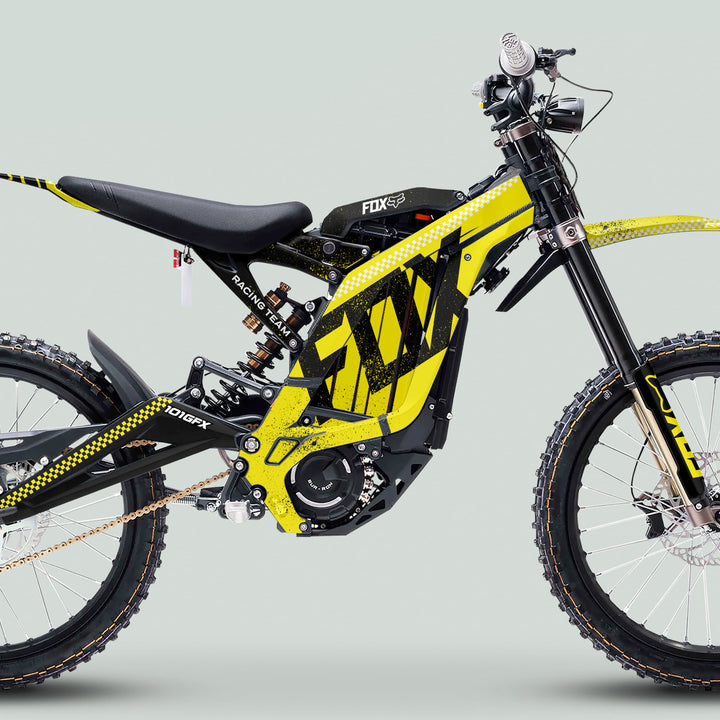 Surron Light Bee X Graphics Kit FOX DUST Yellow Black on an electric off-road bike, highlighting its full-suspension frame, knobby tires, and central battery pack.
