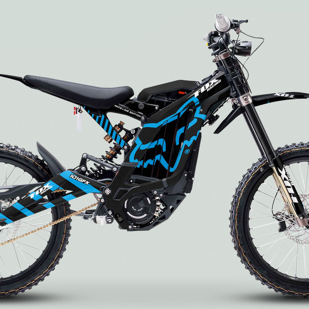 Side profile of Surron Light Bee X Graphics Kit FOX RACE LINE Black Blue on an electric dirt bike, showcasing sleek blue-black graphics and robust off-road components.