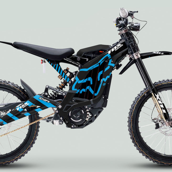 Side profile of Surron Light Bee X Graphics Kit FOX RACE LINE Black Blue on an electric dirt bike, showcasing sleek blue-black graphics and robust off-road components.
