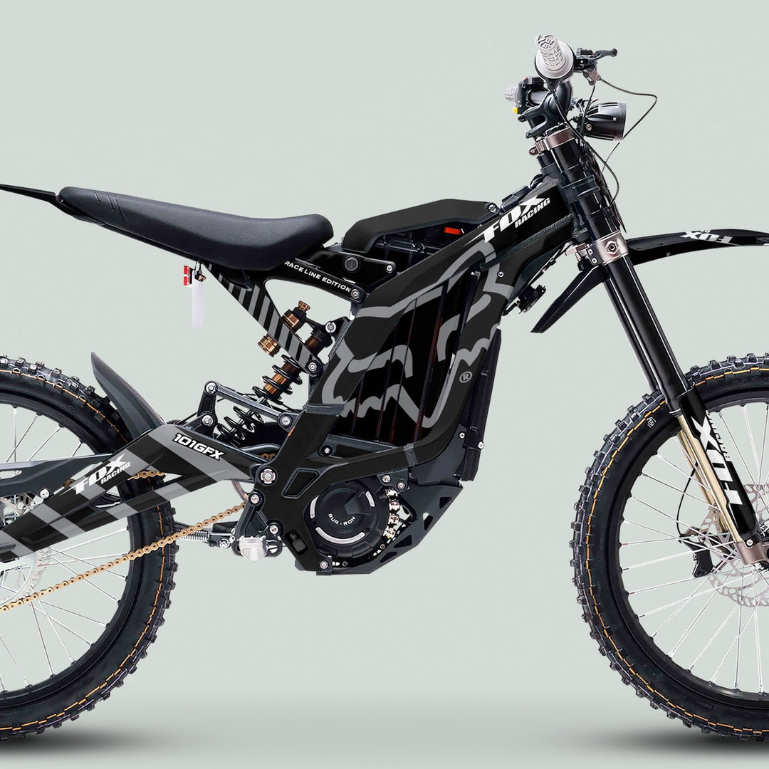 Surron Light Bee X Graphics Kit FOX RACE LINE Black Grey on a full-suspension e-dirt bike, highlighting integrated battery, off-road tires, and mid-mounted motor.