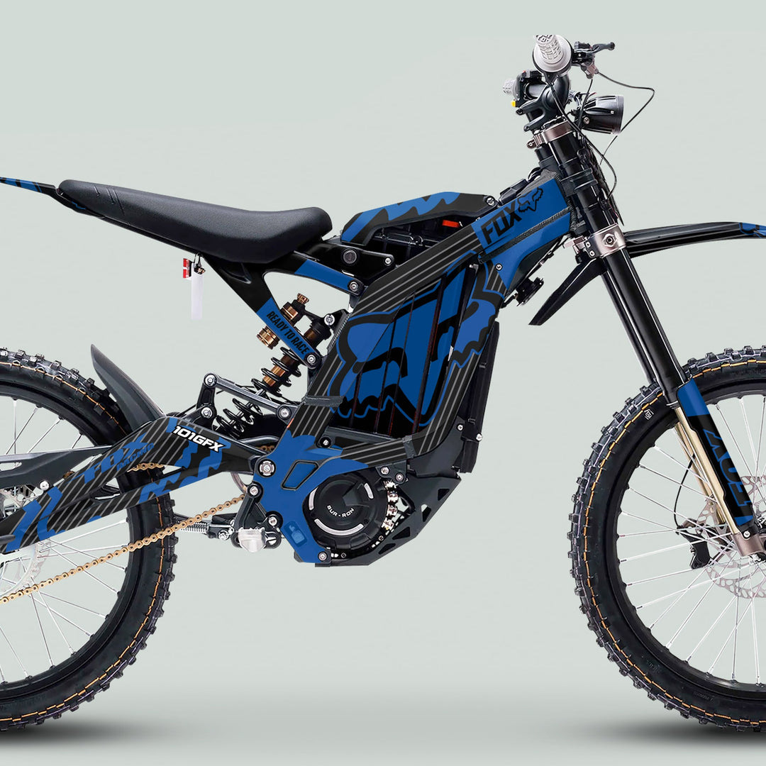 Surron Light Bee X Graphics Kit FOX STRIPES BLACK Blue on an electric off-road bike with full suspension, knobby tires, and FOX branding.