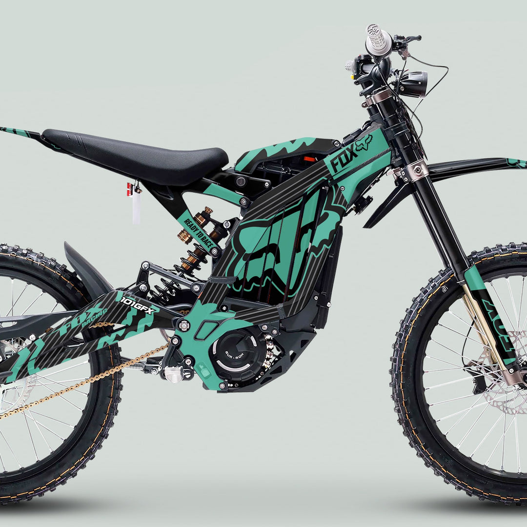 Surron Light Bee X Graphics Kit FOX STRIPES BLACK Mint on a black-teal e-dirt bike, highlighting its sleek, trail-ready, off-road style and durable design.