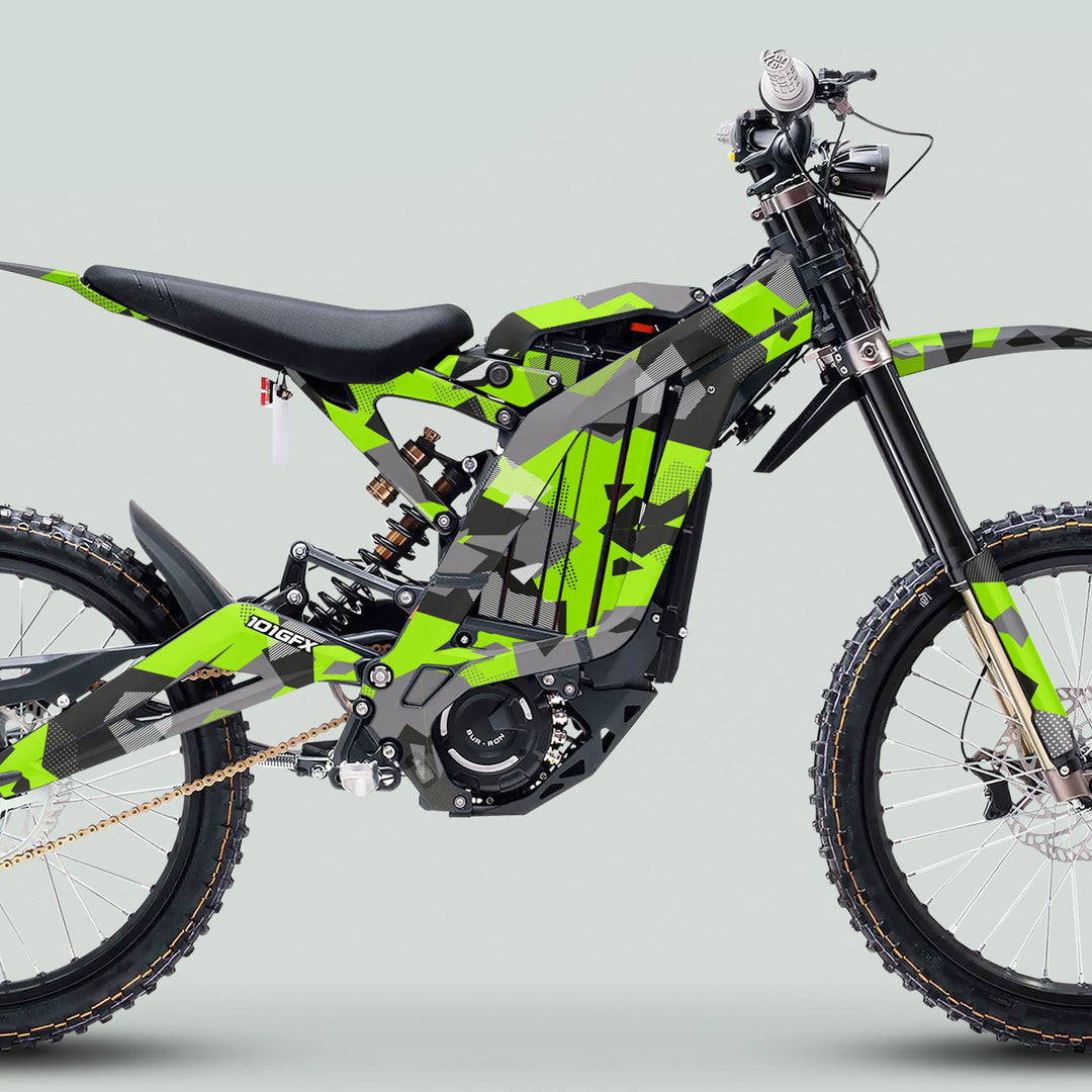 Side view of a Surron Light Bee X with GEOTECH Green graphics kit, showcasing its slim frame, off-road tires, and central electric motor.