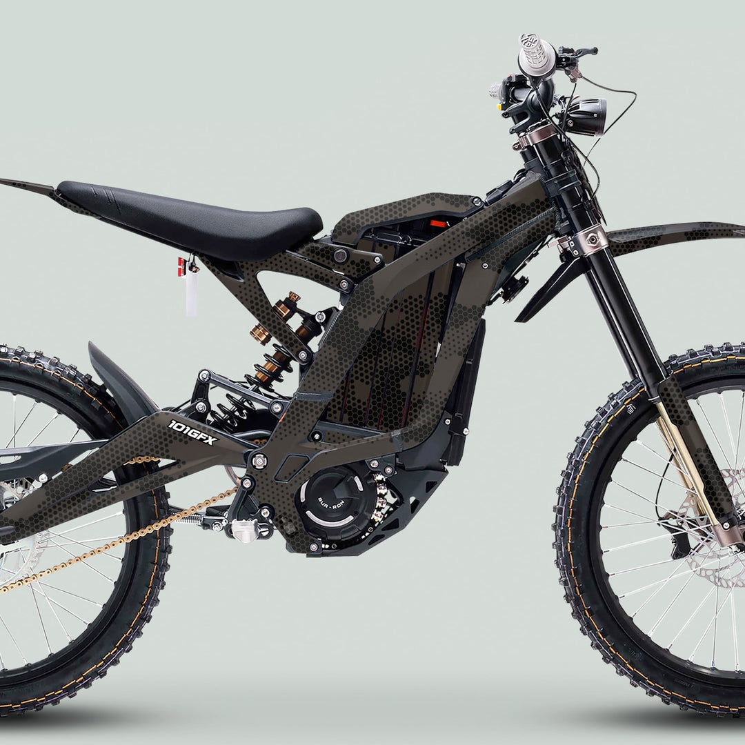 Surron Light Bee X Graphics Kit HEXOCAM Brown on electric off-road bike, showcasing rugged knobby tires, telescopic forks, and protective honeycomb camo design.