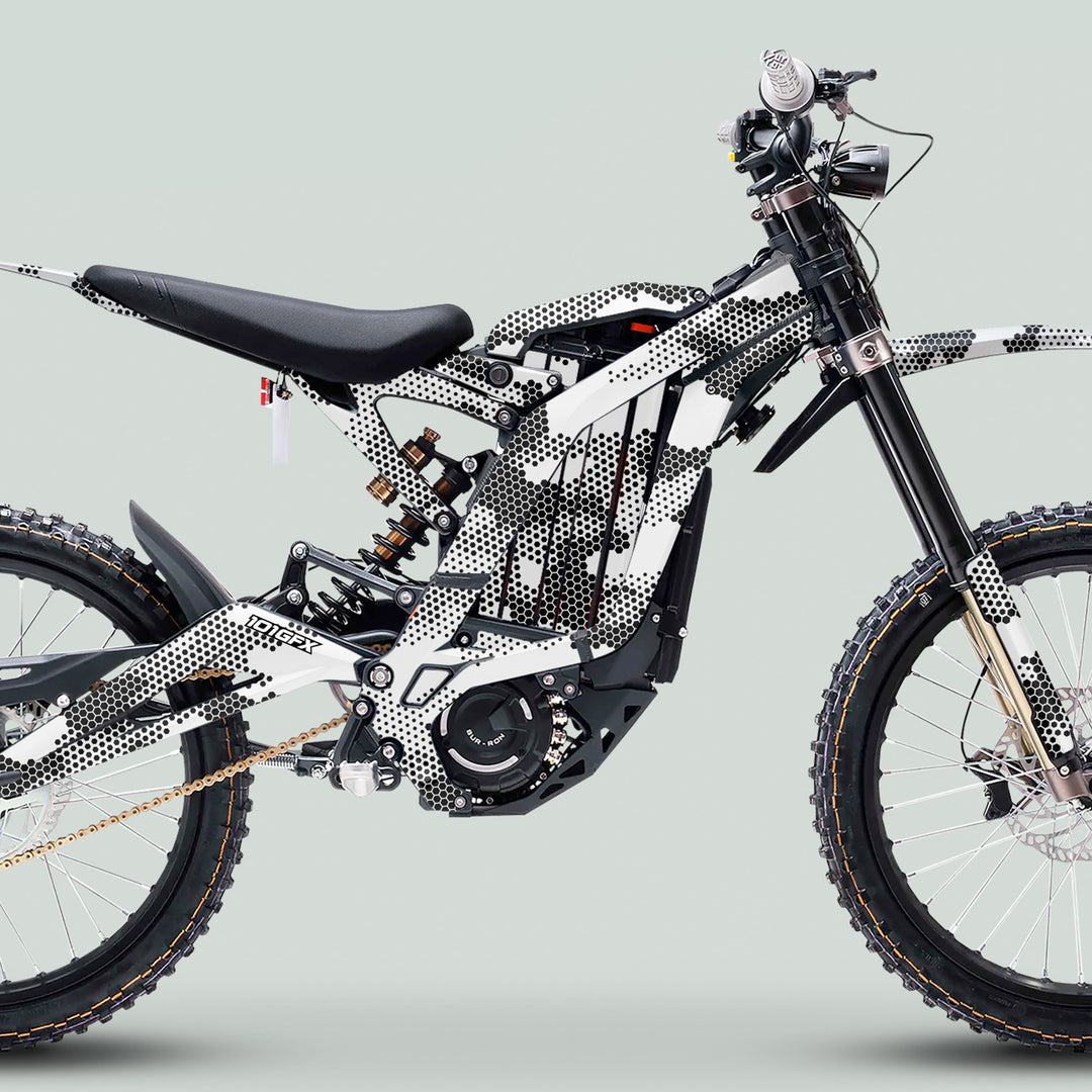 Surron Light Bee X Graphics Kit HEXOCAM White features a white-and-black frame with unique hex-dot graphics, enhancing the dirt-bike's off-road aesthetic and durability.
