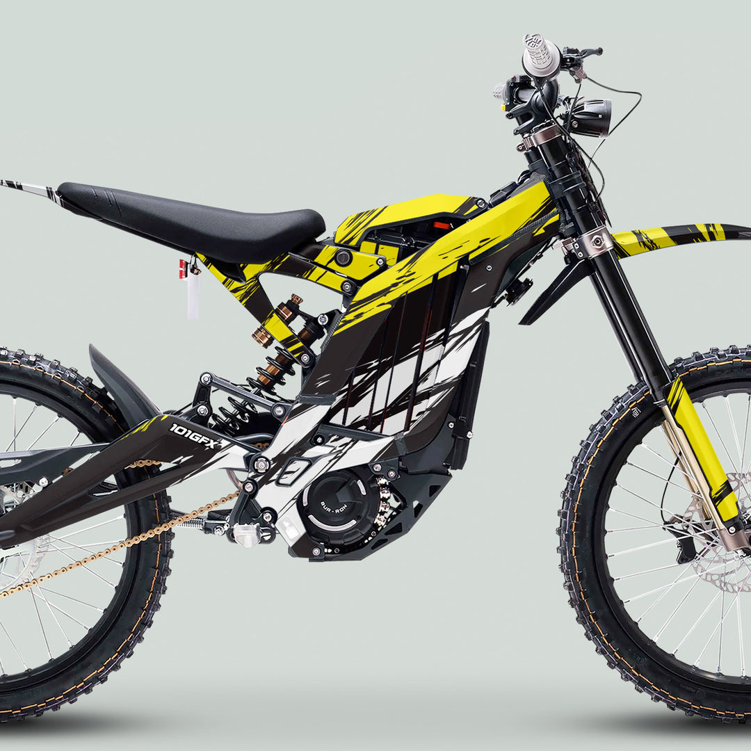Surron Light Bee X Graphics Kit SLICE BLACK Yellow on an electric moto, showcasing glossy laminated decals, knobby tires, and a sleek design for enhanced aesthetics.