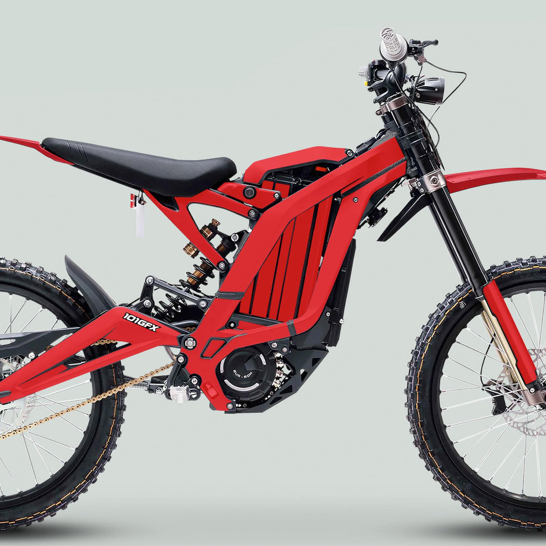 Surron Light Bee X Graphics Kit MONO COLOR Red on a full-suspension e-dirt bike, featuring red laminated decals, enhancing style and protection on rugged terrains.
