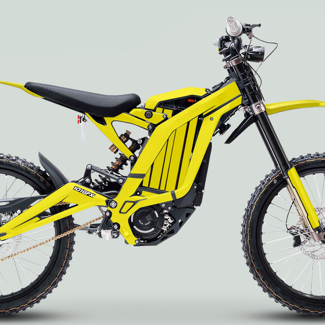 Surron Light Bee X Graphics Kit MONO COLOR Yellow on a dirt bike, showcasing knobby tires, boxed frame, and minimalist bodywork for trail use.