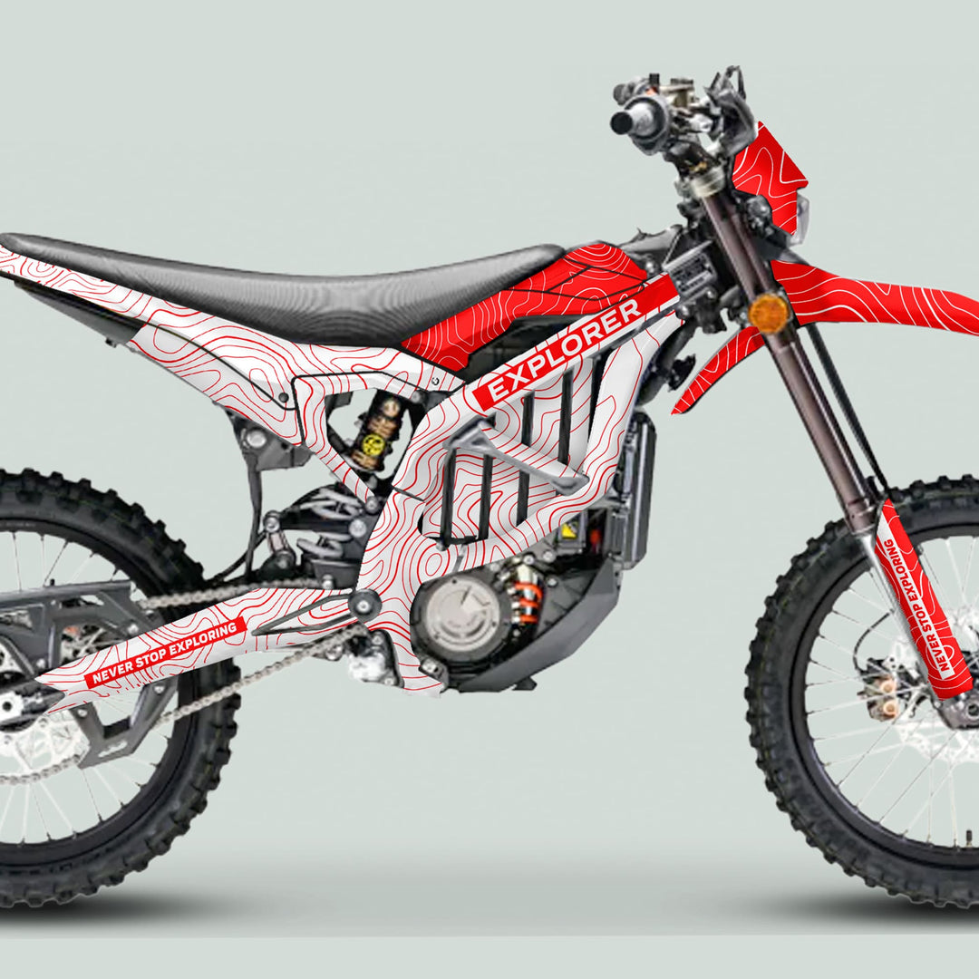 Surron Ultra Bee Graphics Kit EXPLORER WHITE RED on a dirt bike, showcasing topographic map contours and EXPLORER text, enhancing its adventurous look.