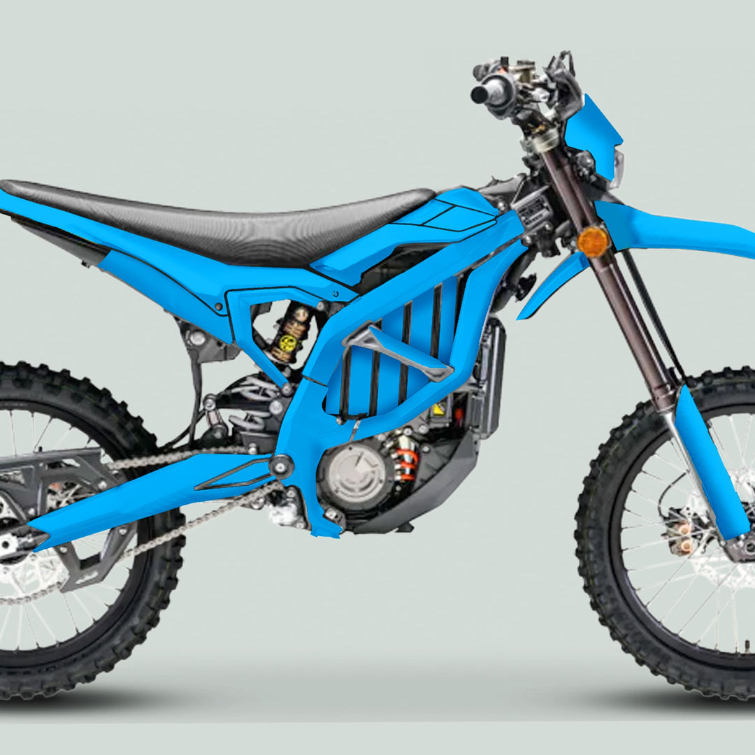 Surron Ultra Bee Graphics Kit Solid Color Cyan displayed on an off-road motorcycle with knobby tires, showcasing vibrant blue body panels and electric drivetrain.