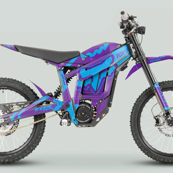 Side profile of a Talaria Sting MX3 MX4 with the FOX STRIPES Purple Cyan graphics kit, showcasing vibrant purple and cyan stripes on the electric off-road motorcycle.