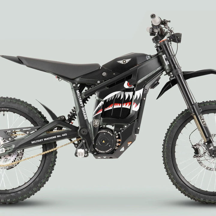 Black off-road electric dirt bike with knobby tires and military-style “shark mouth” graphic from Talaria Sting MX3 MX4 Graphics Kit MILITARY SHARK Black.
