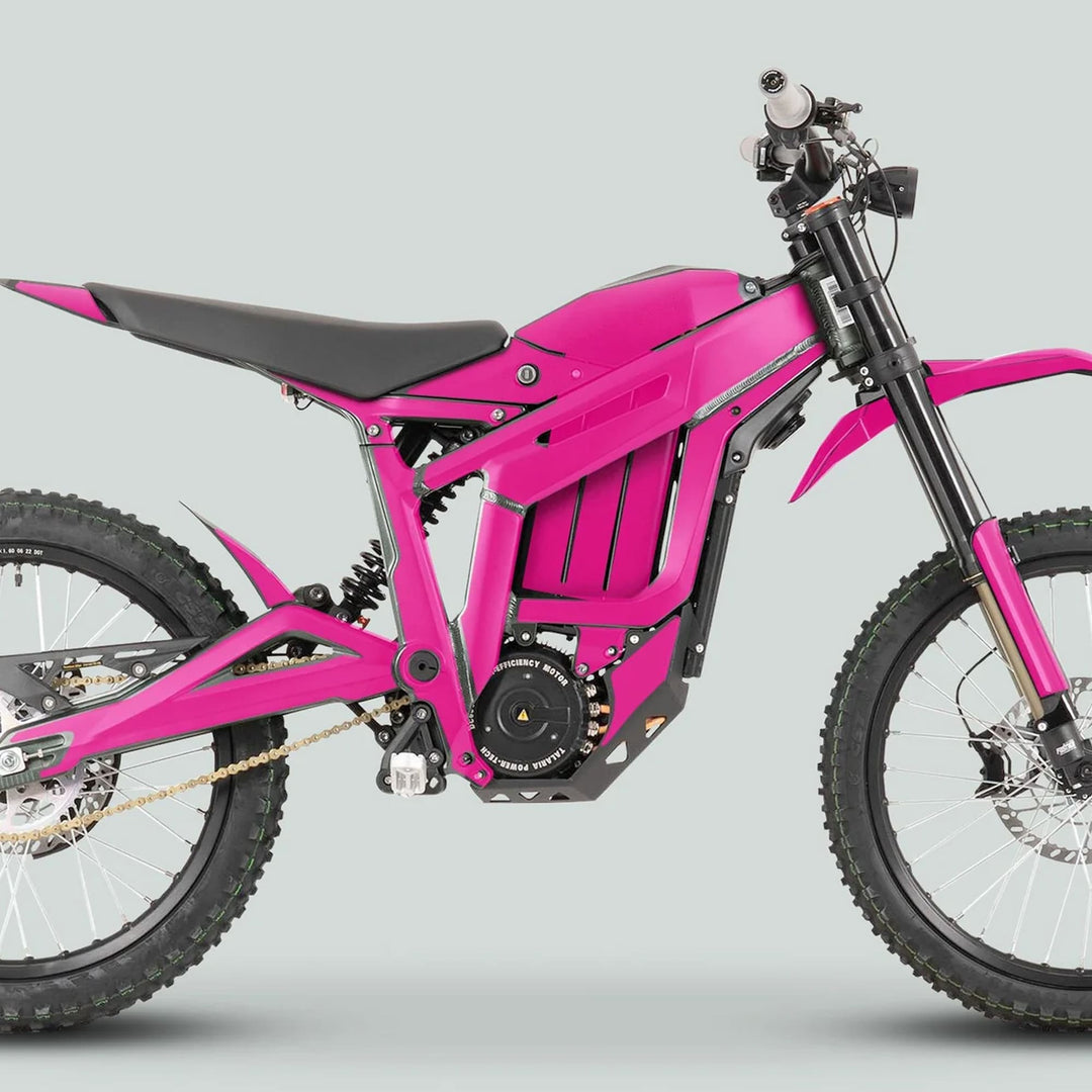 Talaria Sting MX3 MX4 Graphics Kit SOLID COLOR MAGENTA on an electric dirt bike with knobby tires, pink bodywork, and integrated battery, showcasing a sleek, custom fit design.