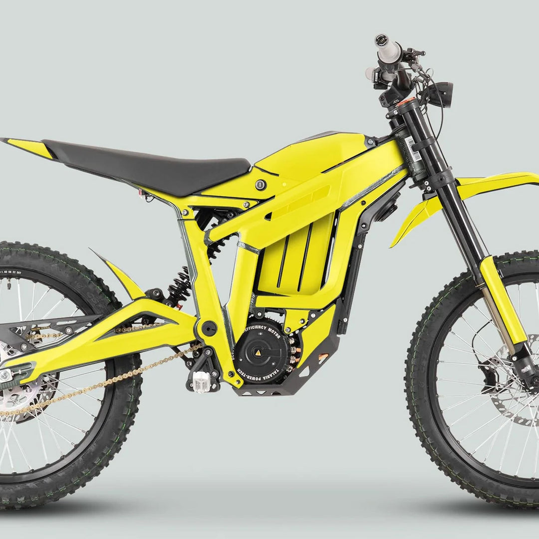 Side profile of Talaria Sting MX3 MX4 Graphics Kit SOLID COLOR YELLOW on an electric off-road motorcycle, highlighting its knobby tires and central battery housing.